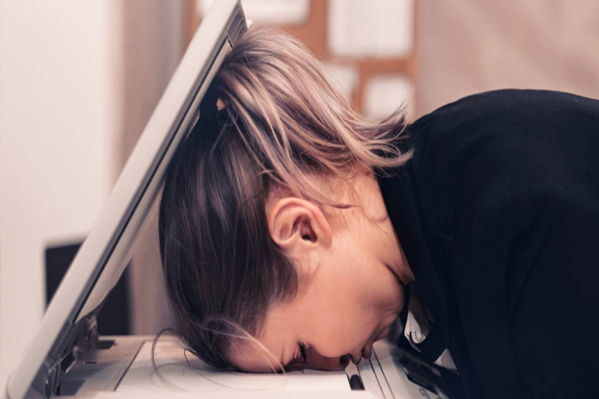 Woman face down on a printer