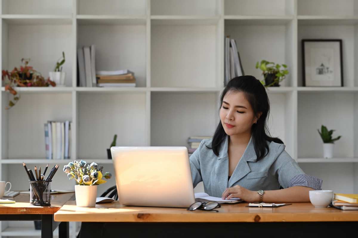 Woman at desk looking at laptop